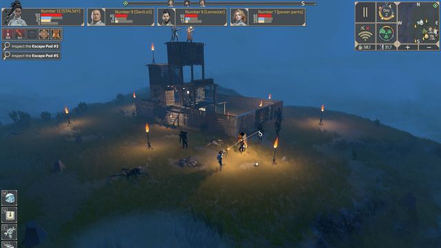 A watchtower base lit by torches at night