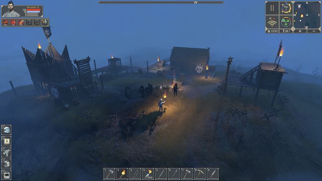 A fortified camp with spiked walls at night