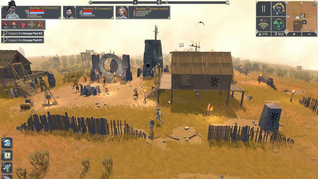 A settlement with a stone ring portal on the desert plain by day